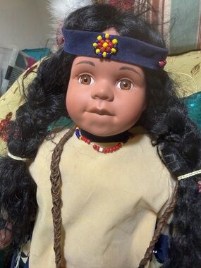 Vintage Brown-Skinned Doll with Blue Headband and Beaded Necklace